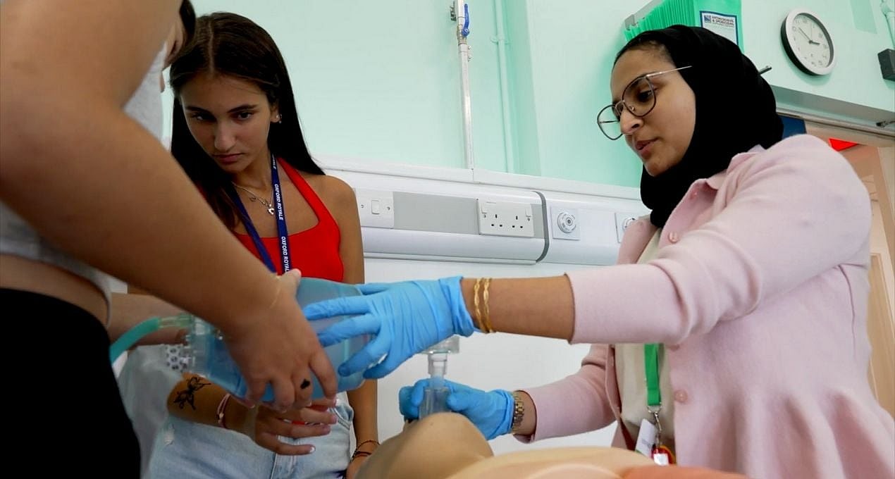 Students being taught medicine at the cambridge summer school using a dummy