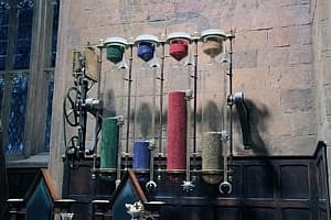 Image shows the House Points counter at Hogwarts, with beads in red, blue, green and yellow representing the scores of the different Houses, from the set of the Harry Potter films.