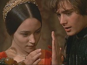 Image shows Romeo and Juliet about to touch their palms together.