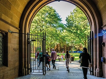Yale summer school, experience life at Yale University, gate onto quad with lush green lawns.