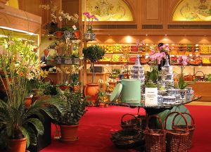 Image shows the beautiful and decadent-looking fruit and flowers section of Fortnum and Mason's in London.