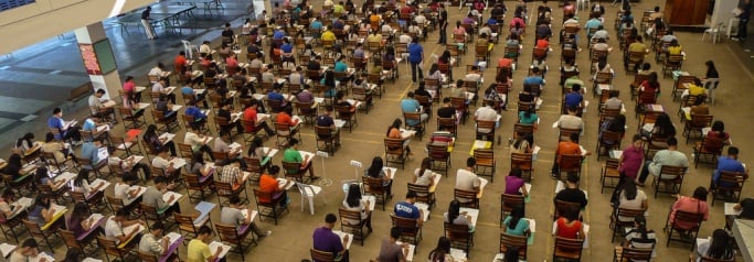 Image shows rows of students in an exam hall. 
