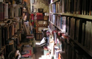 Image shows dusty old bookshelves.