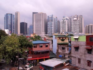 Image shows the contrast between old buildings and skyscrapers in the Philippines.