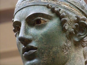 Image shows a close-up of the Charioteer of Delphi.