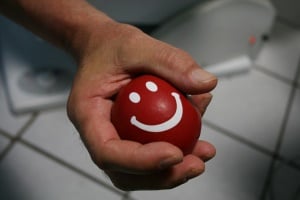 Image shows a hand squeezing a stress ball.