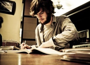 Image shows a student studying in a coffee shop. 