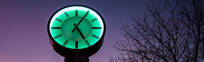Clock against purple sky.