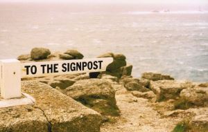 Image shows a signpost that reads "to the signpost."