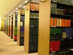 Image shows rows of bookshelves in a library.