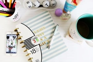 Notebook with pen and desk items