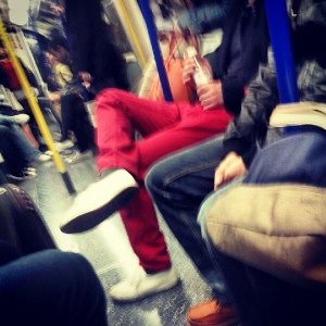 image shows a man in red trousers