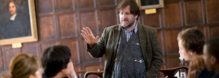 Oxford teacher speaking in oak panelled room