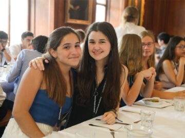 Yale summer school, experience life at Yale University, Smiling happy female students at dinner table.