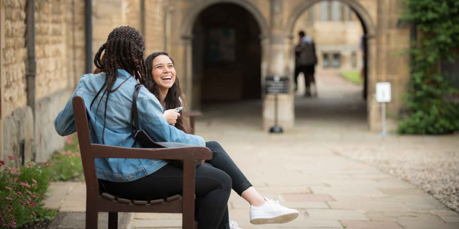 Girls talking on bench in Oxford