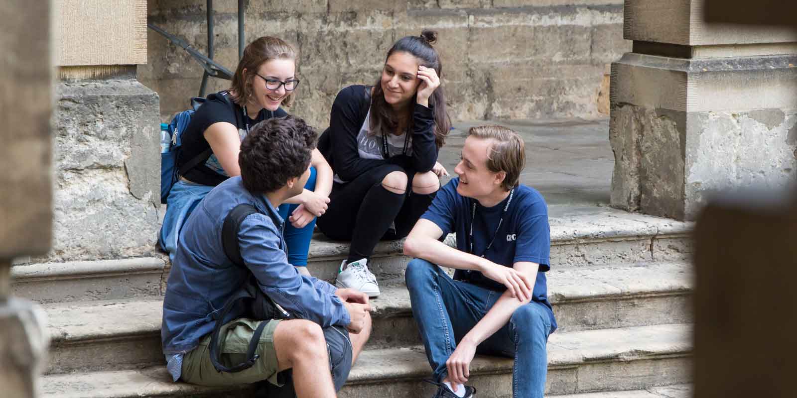 Students sitting on steps at Oxford college